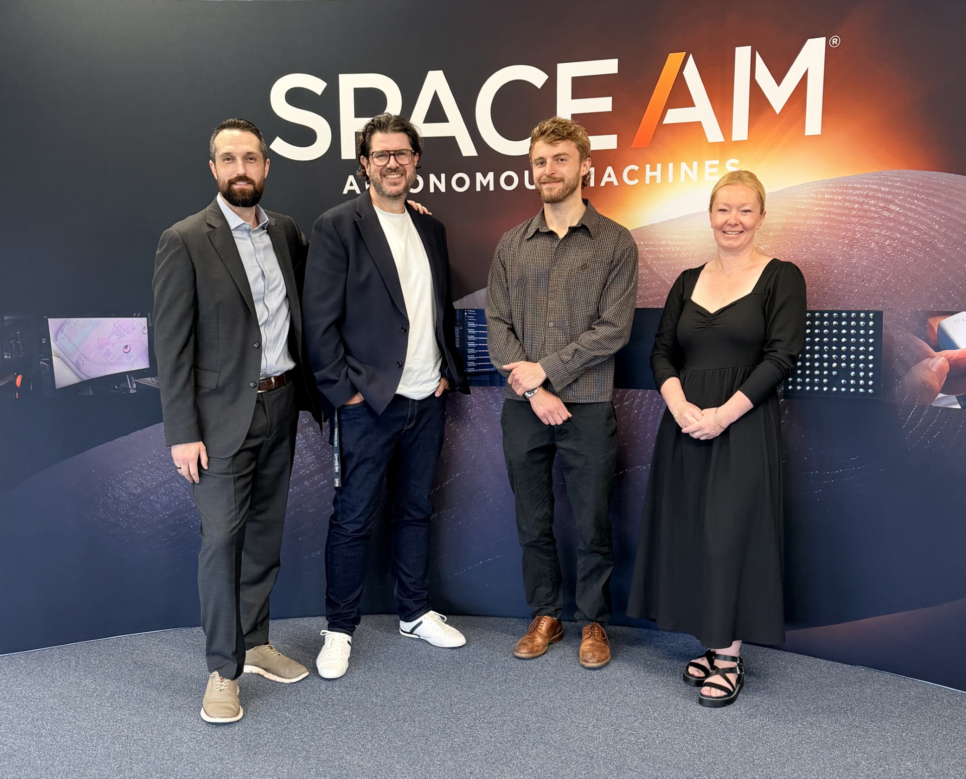 The SpaceAM team in front of their Autonomous Machines backdrop