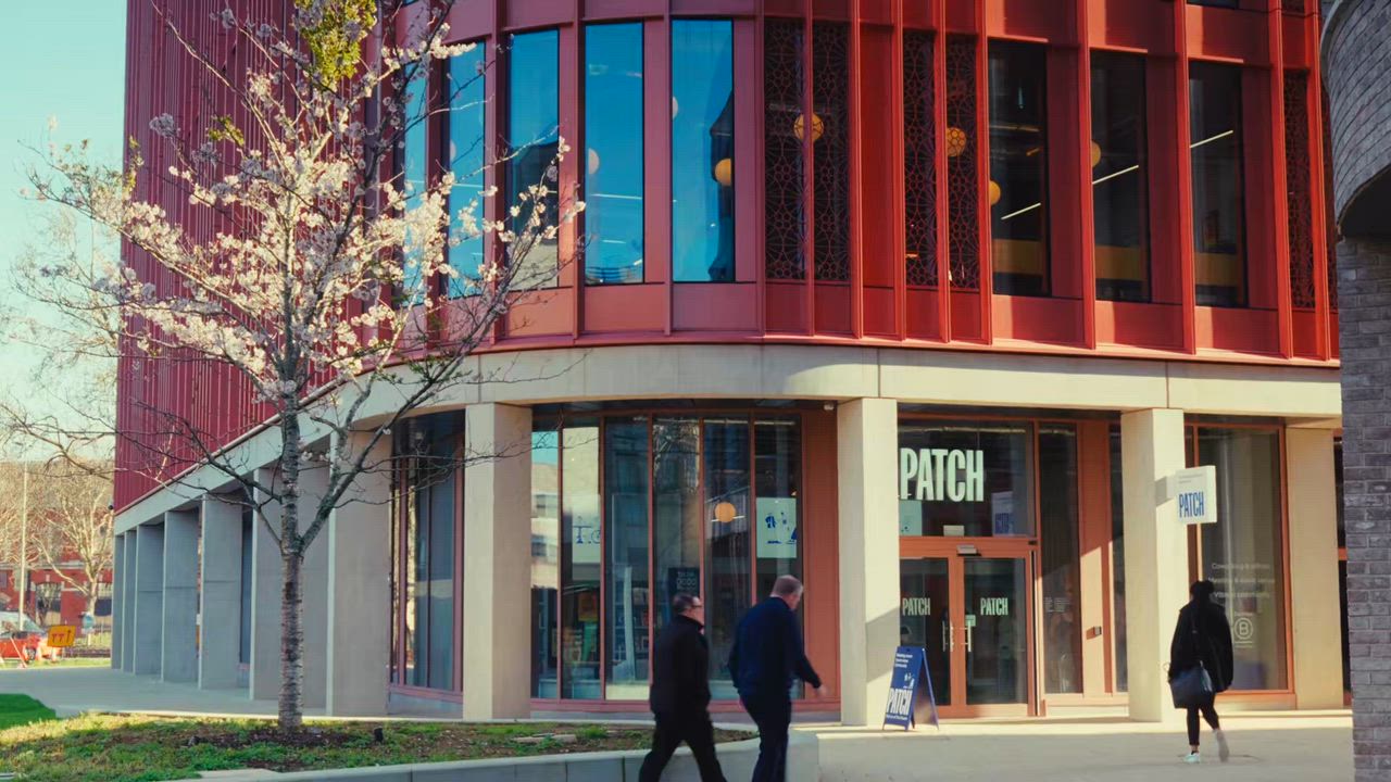The Patch workspace building at The Forum in Gloucester city centre, a modern red-brick digital innovation campus with a cherry blossom tree outside, venue for Thursday's artificial intelligence day.